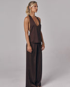 Side view of Paloma chocolate brown satin lounge pants with matching satin top in a studio setting.