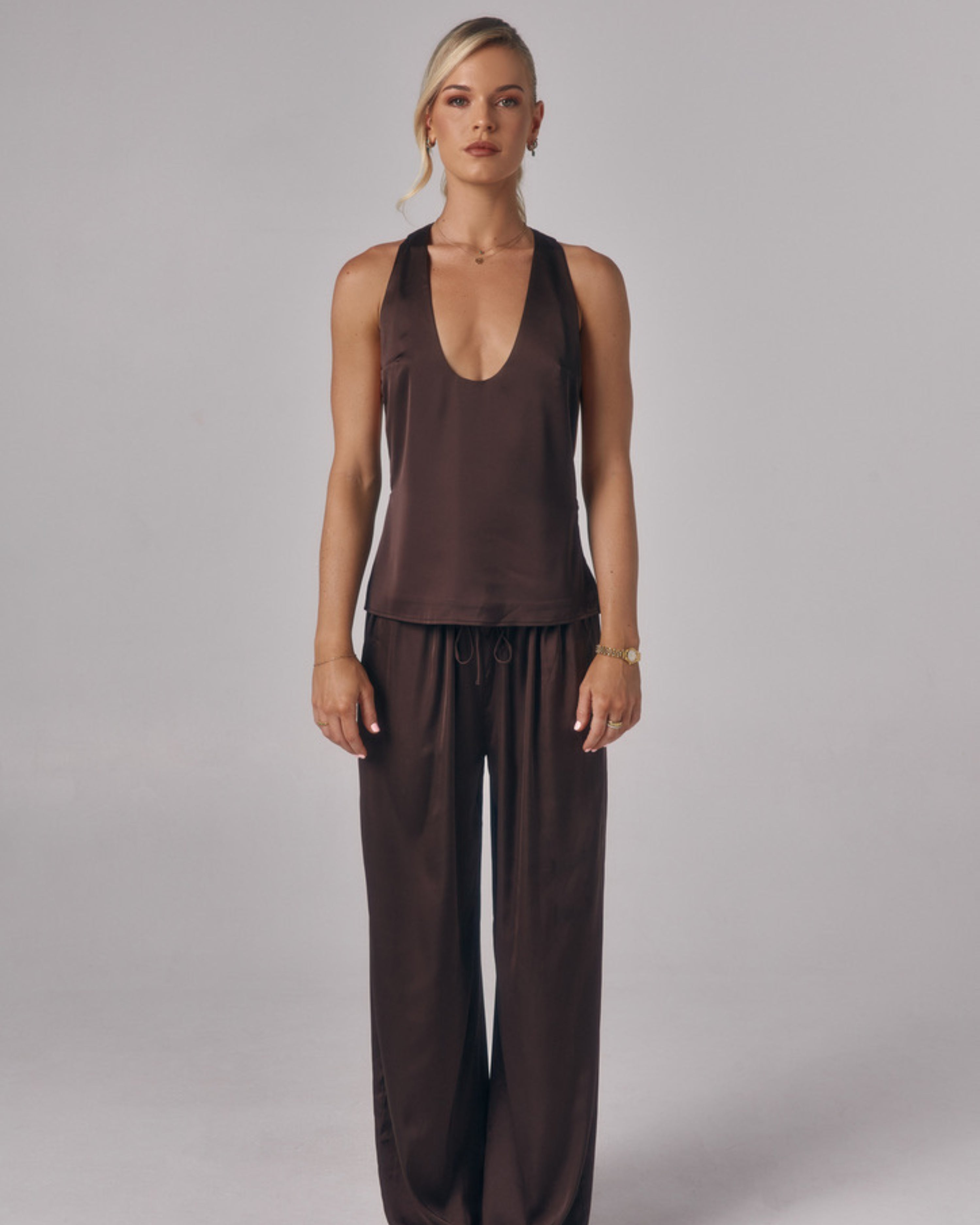 Model wearing the Paloma Top in Chocolate, shown front-on with a scoop neckline in a studio setting.