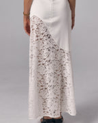 Close-up of Soleil ivory strapless maxi dress showing curved lace skirt panel and smooth bodice detail.