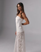 Side profile of Soleil ivory strapless maxi dress with fitted bodice and lace maxi skirt in a studio setting.